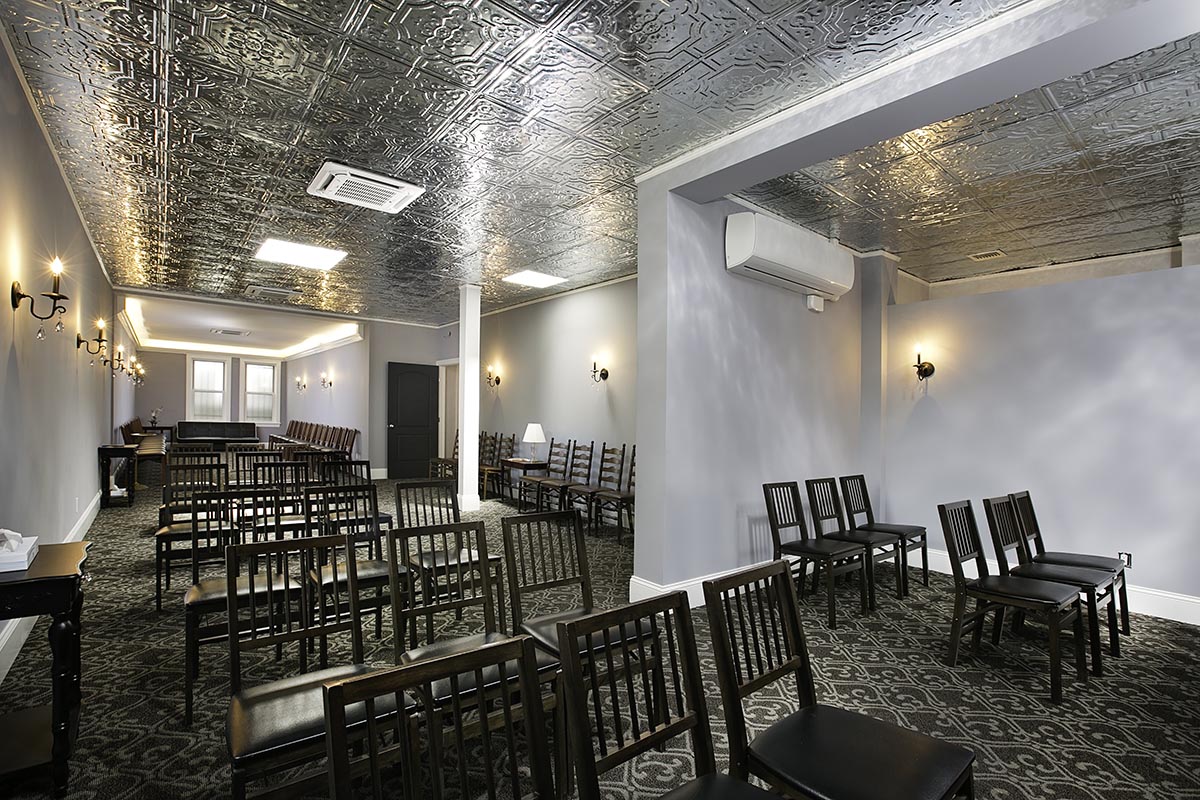 San Jose Funeral Home Chapel with chairs on carpet under silver ceiling